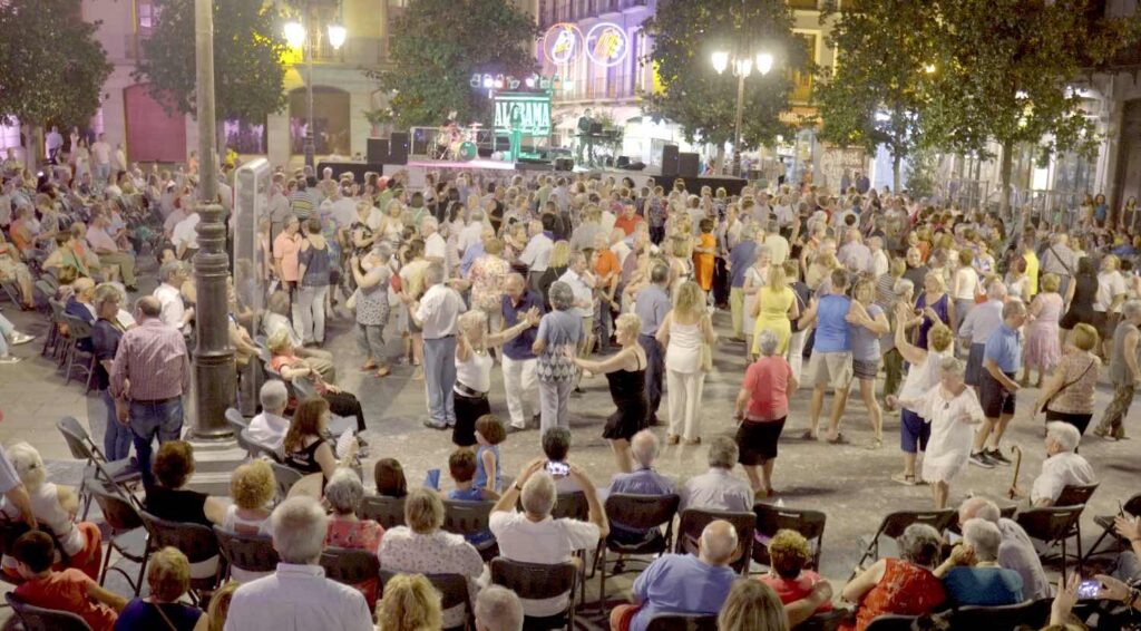 Photo of people dancing in the street in Spain.