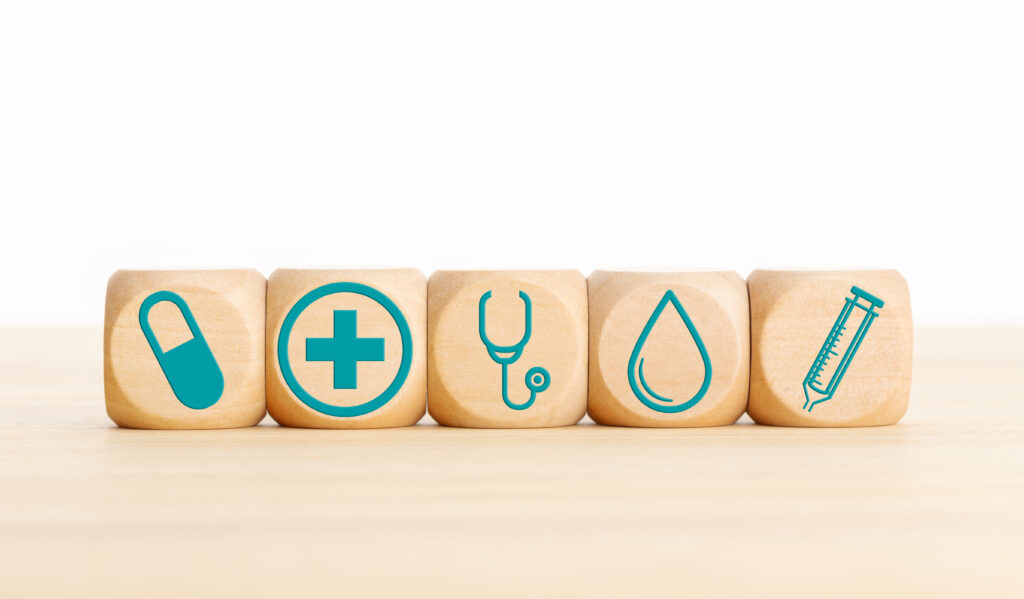 Health care or medicine concept. Wooden blocks with medical icon on table. 