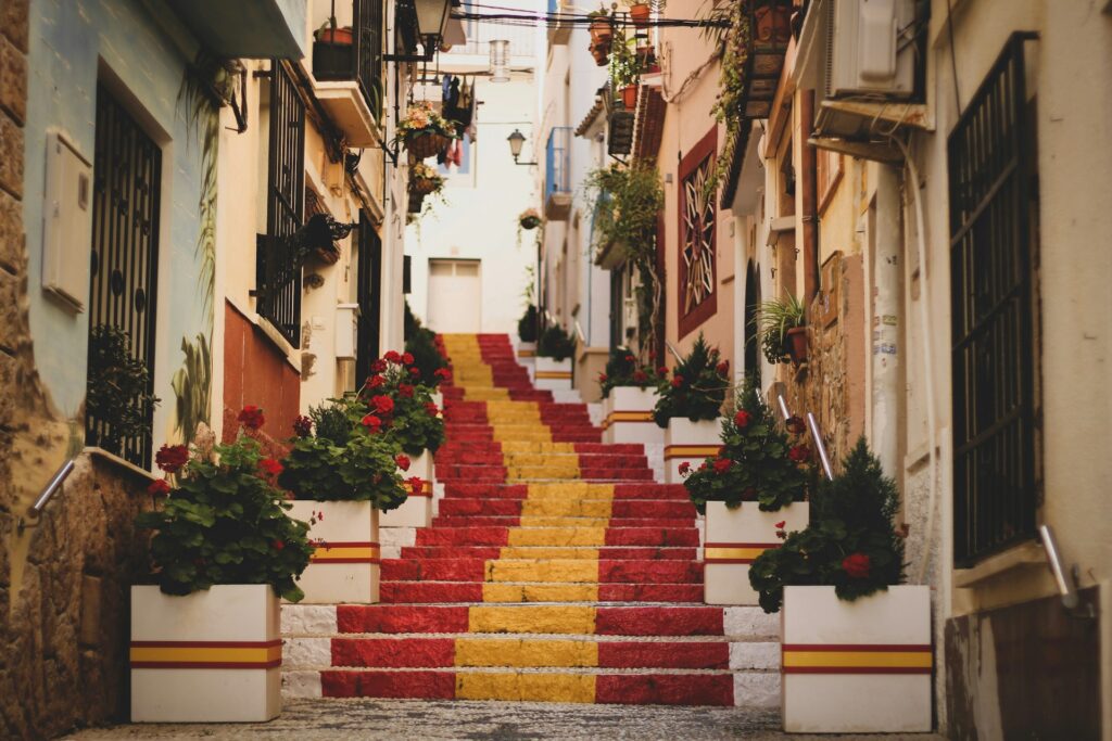 Photo of Spain flag on steps in street. 