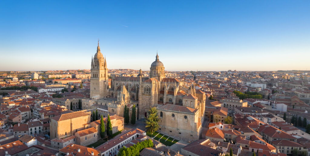 Panoramic aerial cityscape of Salamanca, Spain with building of New Cathedral on sunrise.