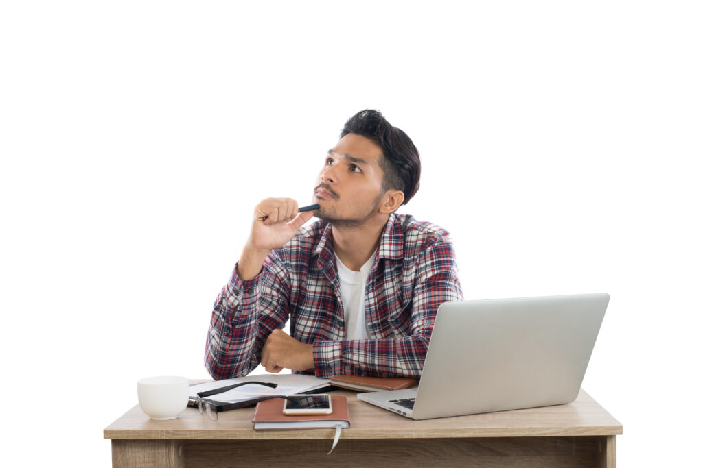Photo of young man sitting at his working place.