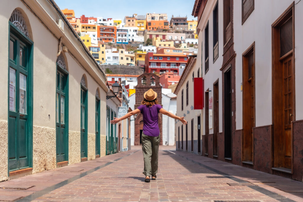 Photo of person on vacation walking through the city of San Sebastian de la Gomera next to the Iglesia De La Asuncion, Canary Islands.