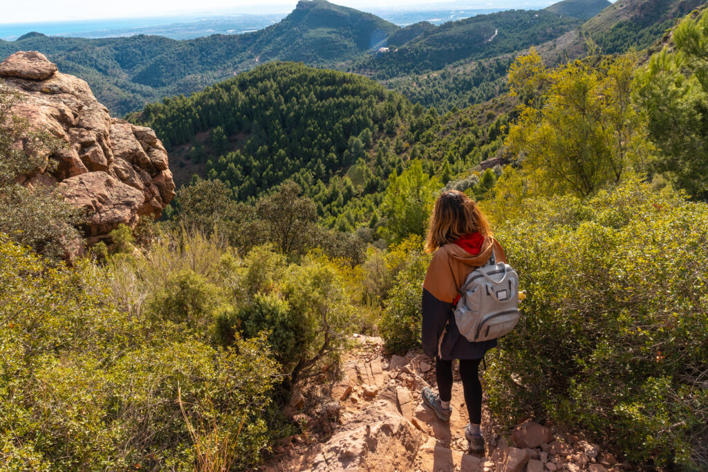 A photo of young hiker female at top of the El Garbi mountain, Sierra Calderona, Valencia, Spain.