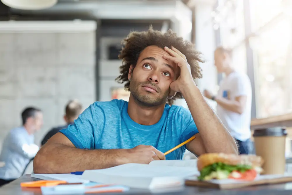 Photo of man studying for exam at desk.
