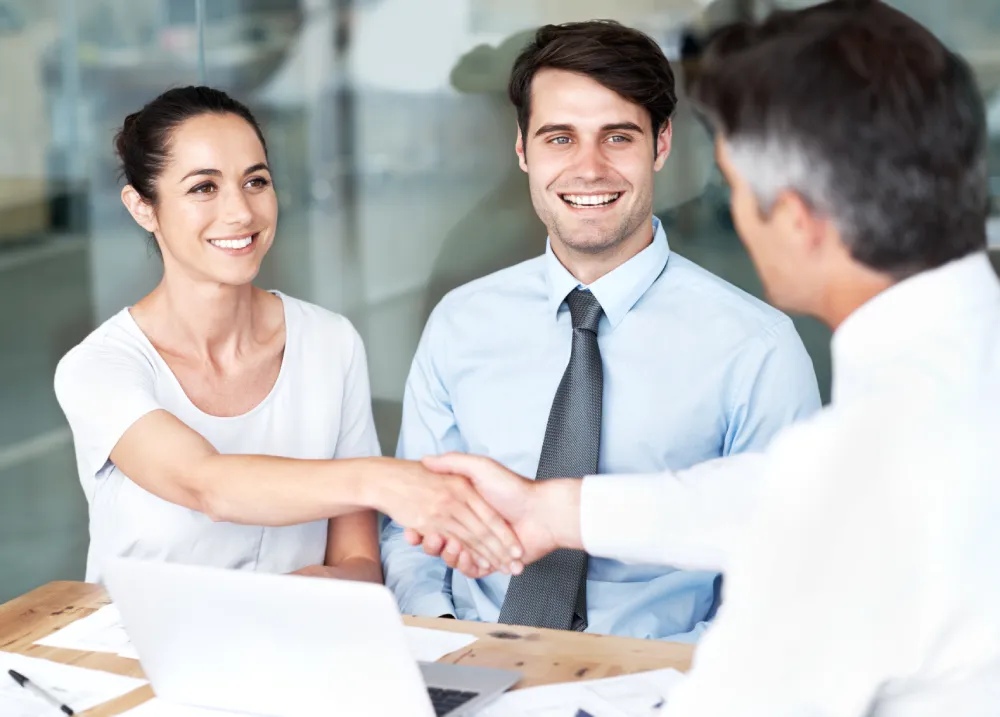 Study abroad company in Spain student smiling in a sunny Spanish city plaza.