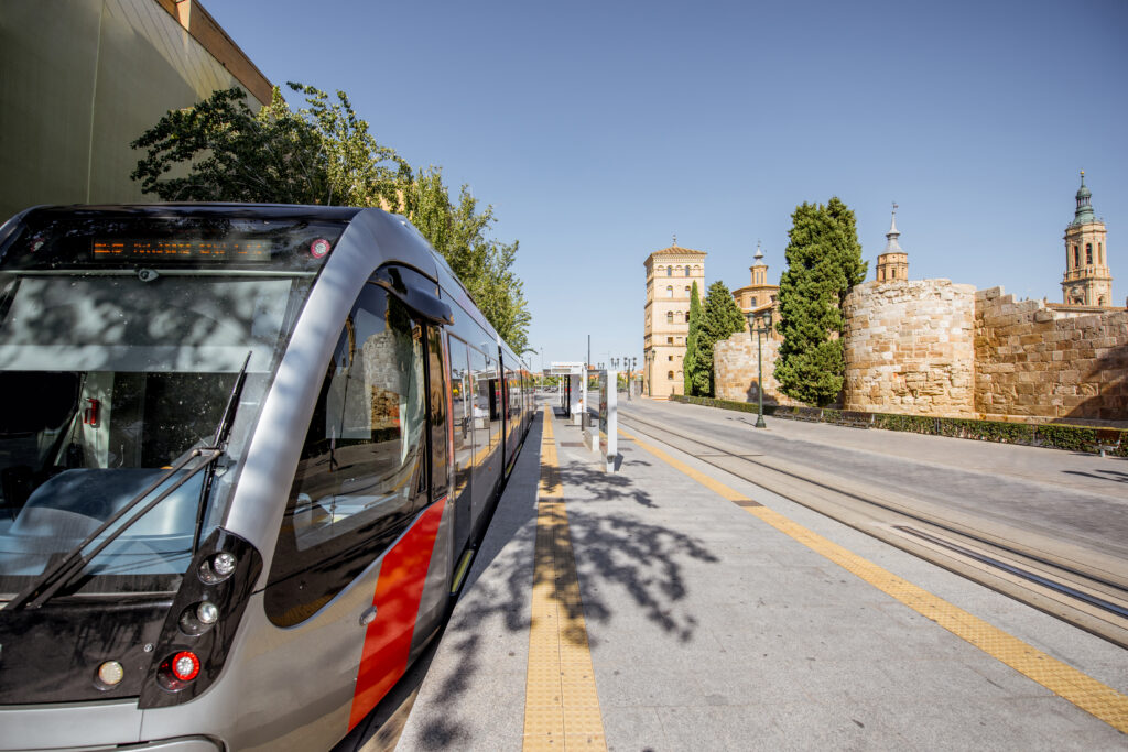 Photo of street view with modern tram in the center of Zaragoza city in Spain.