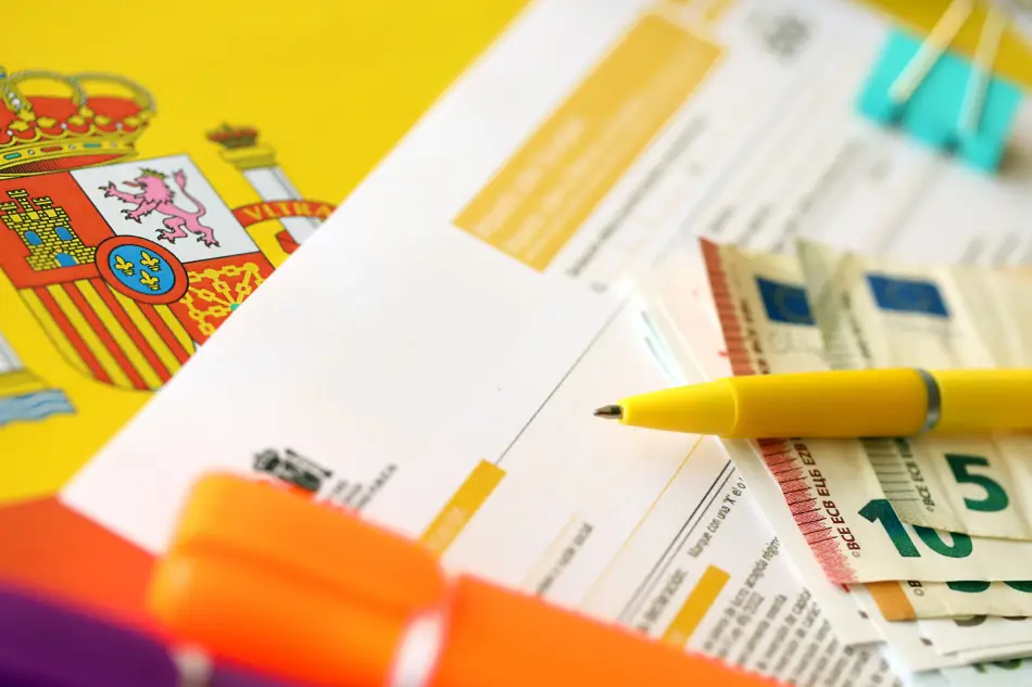 Money, paperwork and Spanish flag close-up. Money, paperwork and Spanish flag close-up.